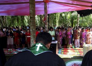 Residents pray as they attend Sunday mass at a temporary shelter near a burned church at Suka Makmur Village in Aceh Singkil